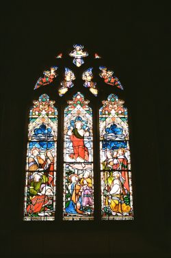 Ornate stained glass window with religious figures.